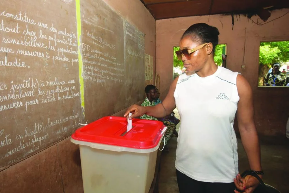 A woman casts her vote at a polling station during the parliamentary election, in Cotonou, Benin, January 11, 2026. REUTERS