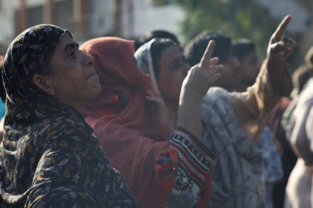 Relatives wait for news of persons missing in the fire that broke out in the Gul Plaza Shopping Mall in Karachi. – Reuters