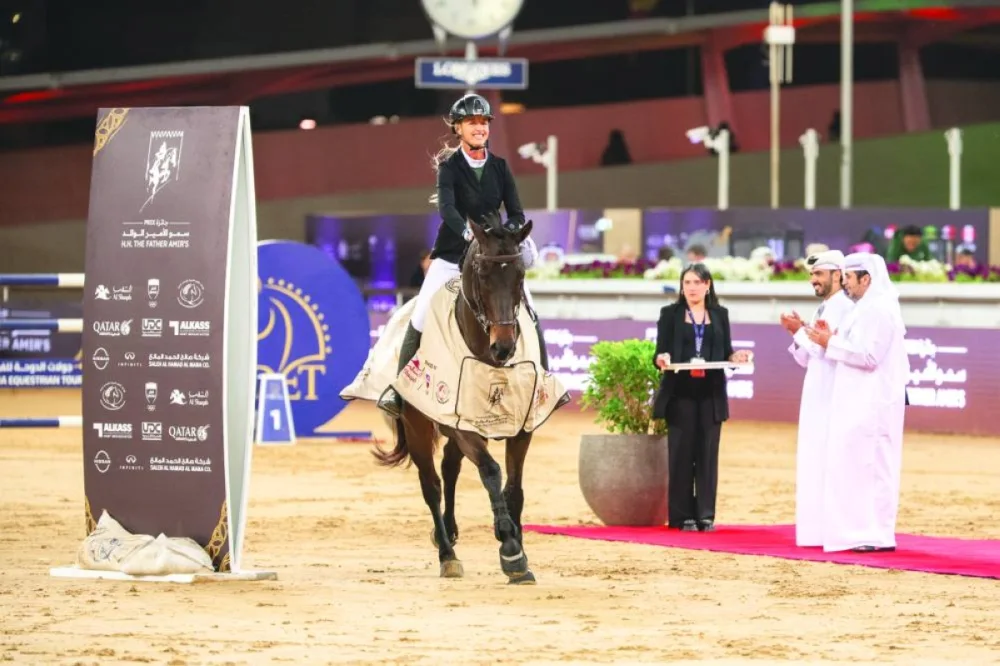 Kristen Vanderveen celebrates with her 12-year-old gelding Bull Run’s Jireh after winning the CSI5* jump-off 155cm class during the final round of the HH The Father Amir’s Prix at Al Shaqab yesterday. The winners of the class were presented trophies by Abdullah al-Qashouti, the tournament's Marketing and Communications Director.
