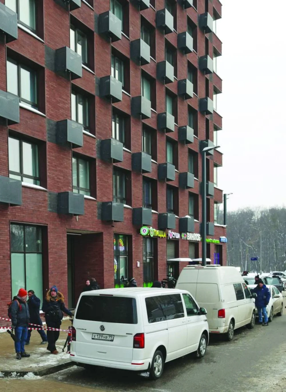 
Law enforcement officers and journalists work outside a residential building where the assassination attempt on Russian Lieutenant General Vladimir Alekseyev took place in Moscow, yesterday. 