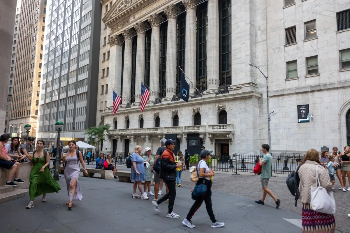 NEW YORK: People walk outside of the New York Stock Exchange (NYSE) in New York City. – AFP