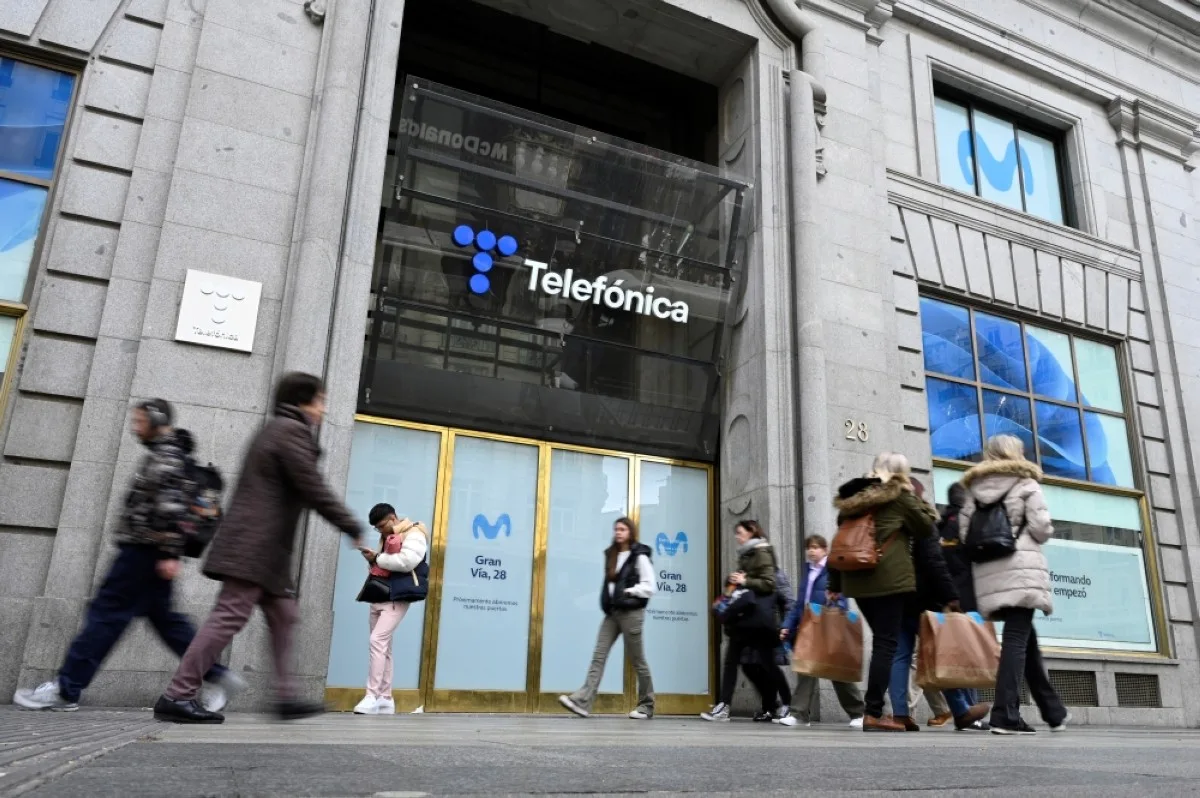 MADRID: Pedestrians walk in front of the Telefonica headquarters in Madrid. – AFP