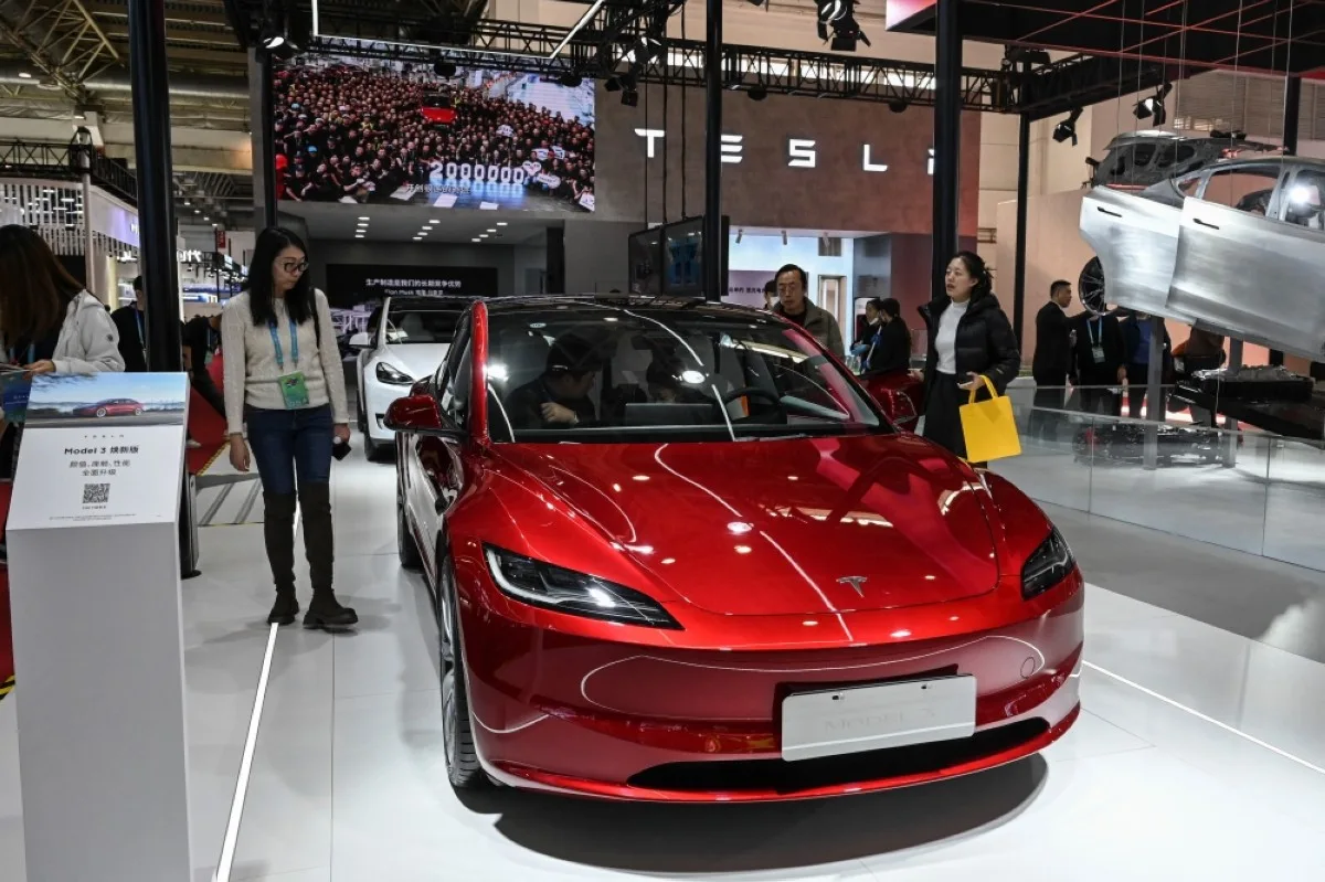 BEIJING: People try Tesla&#039;s electric vehicle Model 3 at its booth during the China International Supply Chain Expo (CISCE) in Beijing on December 1, 2023. -- AFP