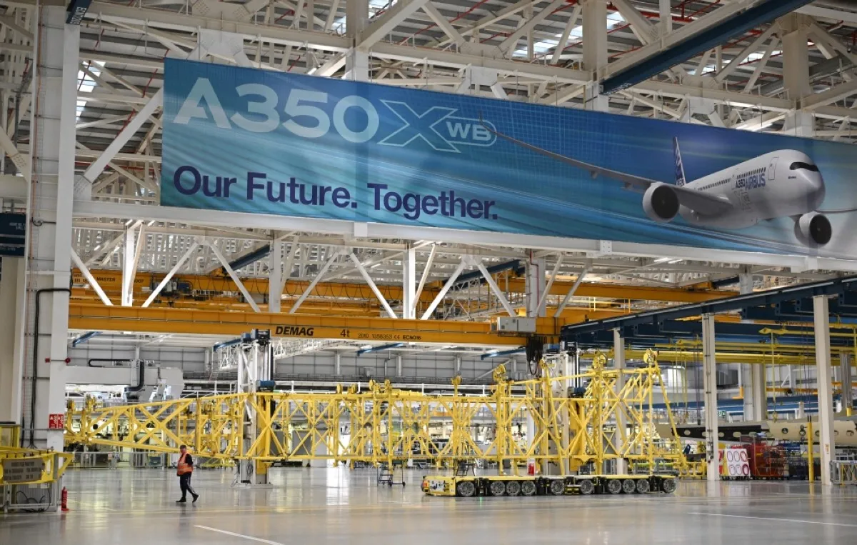 BROUGHTON: Workers are pictured on the Airbus A350 wing manufacturing floor at the Airbus Broughton plant in north Wales. – AFP