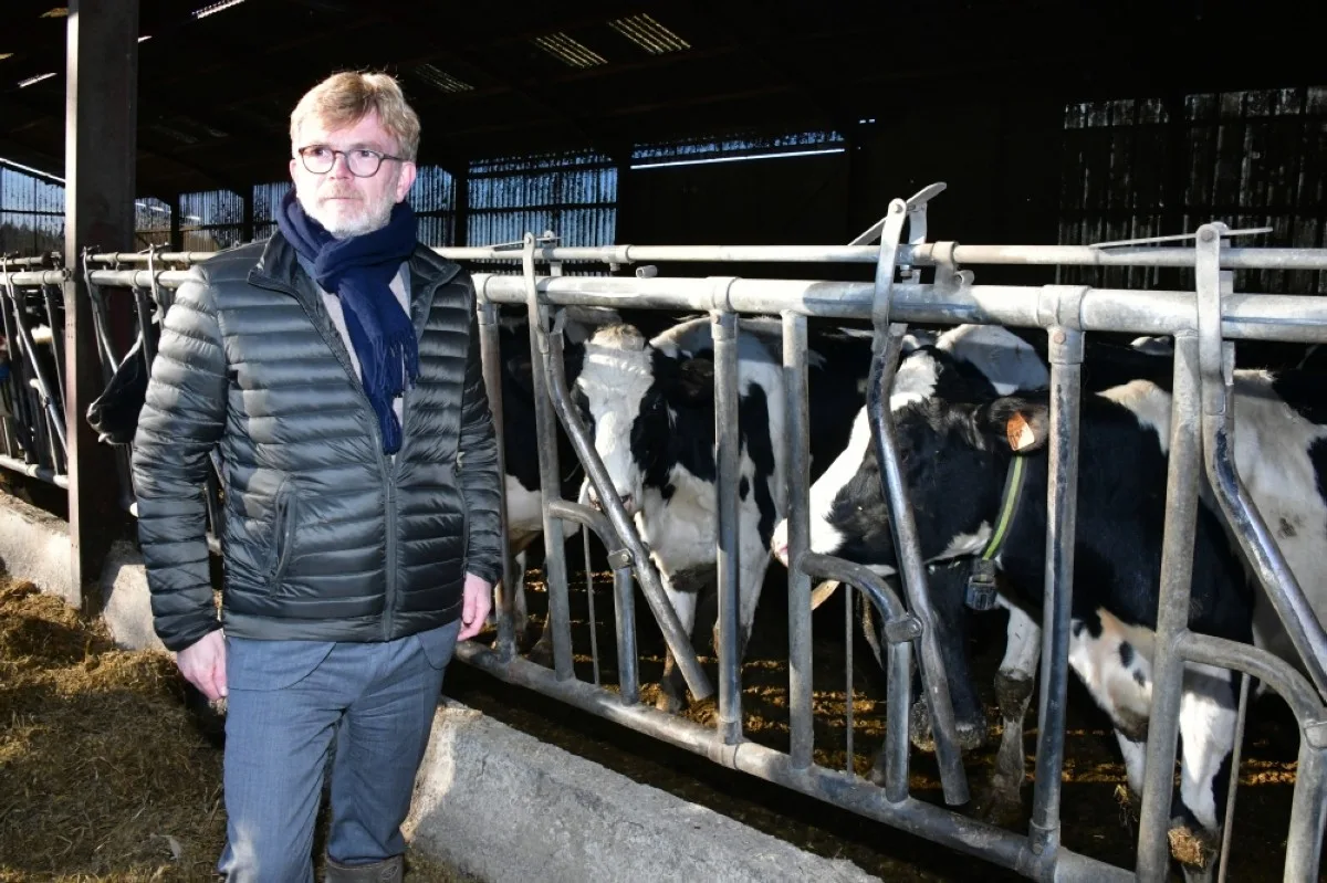 MASSAY, France: French Agriculture and Food Sovereignty Minister Marc Fesneau poses next to cows as he attends a visit at a farm in Massay, central France. – AFP
