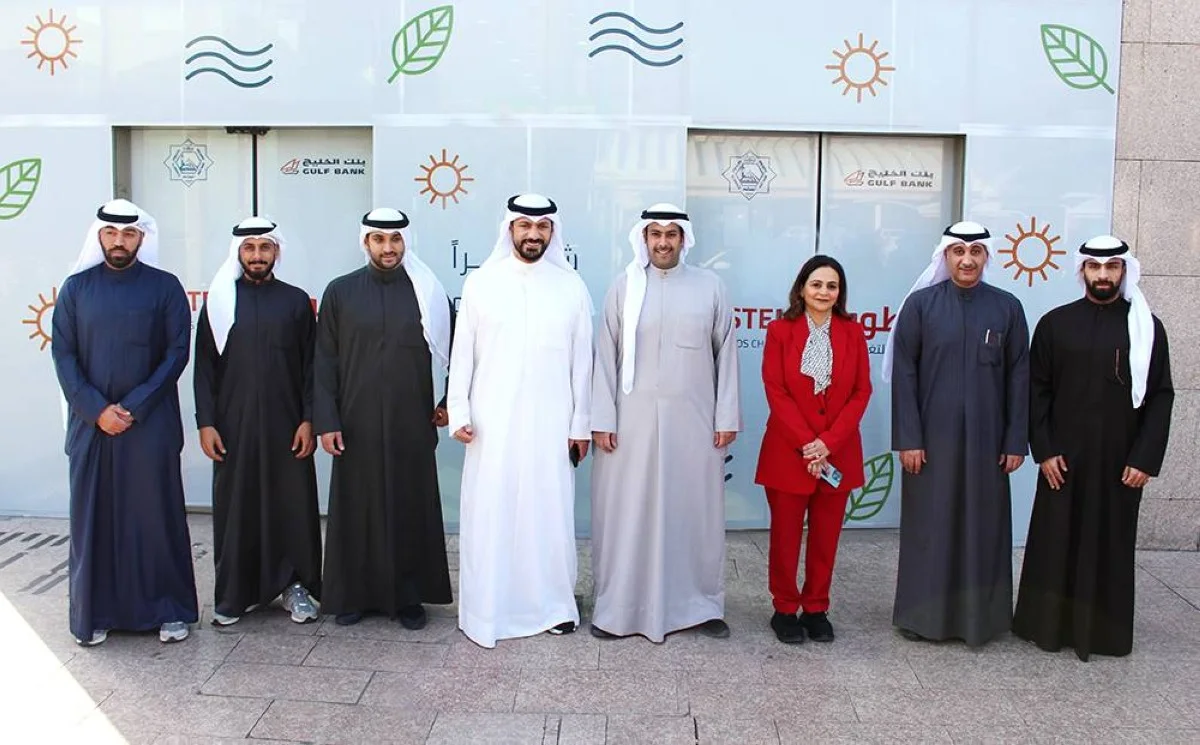 A group photo of representatives of the Gulf Bank and members of the Dahiya and Mansouriah co-op societies with Ahmed Al-Amir and Ahmed Al-Rashed Al-Khaleej in the center.