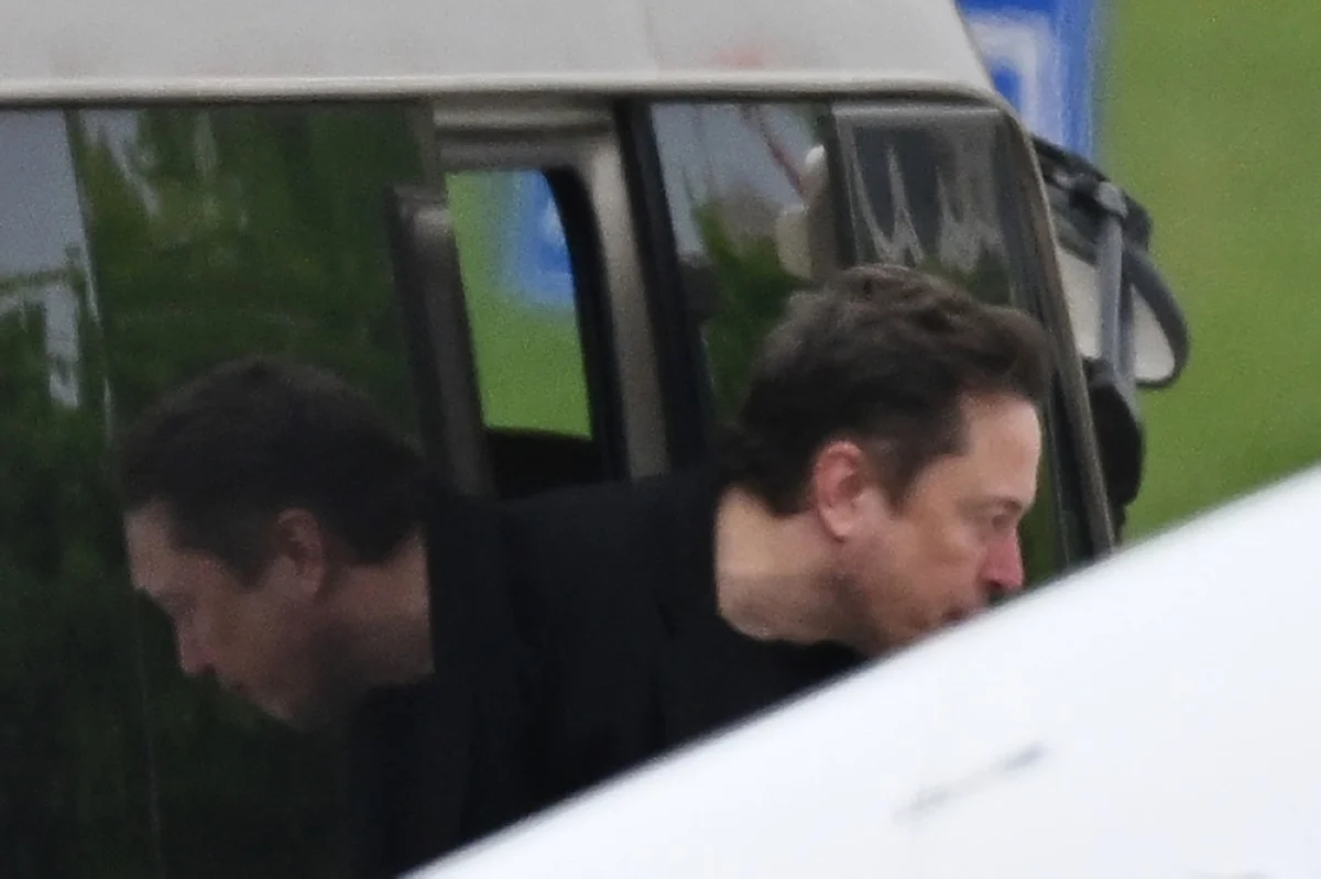 BEIJING: Tesla CEO Elon Musk gets off a minibus before boarding his private plane at Beijing airport on April 29, 2024.-- AFP

