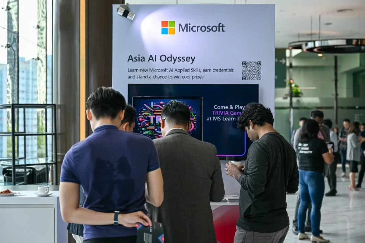 KUALA LUMPUR, Malaysia: Participants check a Microsoft booth before CEO Satya Nadella&#039;s speech during an event named Microsoft Build AI Day in Kuala Lumpur on May 2, 2024. -- AFP