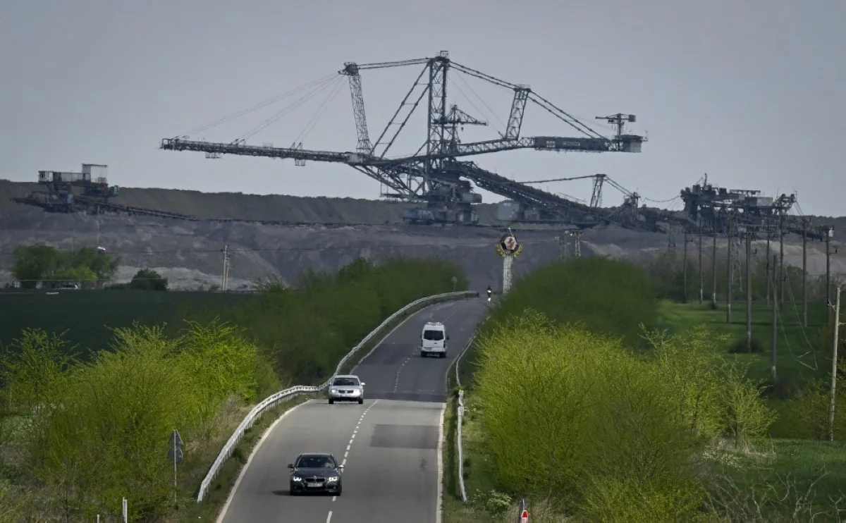TROYANOVO, Bulgaria: This photograph taken on April 12, 2024, shows cars driving on a road past the Troyanovo I coal mine, near the village of Troyanovo, eastern Bulgaria. -- AFP