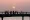 This file photo shows people fishing from a pier at sunset in Kuwait City.