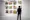Visitors look at Reza Doust's artwork. 