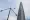 في هذه الصورة حمامة تطير من عمود إنارة أمام برج لوتي وورلد.