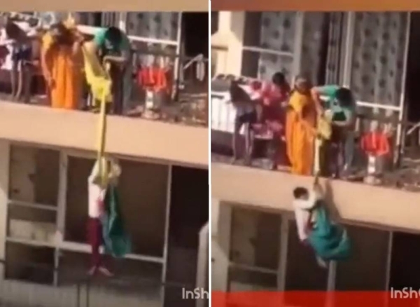 فيديو صادم.. شاهد: امرأة تخاطر بحياة ابنها وترفعه بقطعة قماش من الطابق الـ19 لاستعادة ردائها