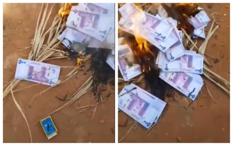 شاهد.. فيديو متداول لـ"سوداني" يشعل النيران  في  أموال من فئة الـ 500 جنيه