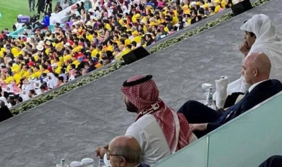 Witness: The Crown Prince wears the Qatar national team scarf during the opening match