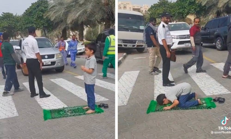 شاهد.. طفل يصلي وسط شارع عام ويعيق مرور السيارات  وحارس أمن يقف بجانبه!