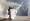 متظاهر يرد قنبلة مسيلة للدموع بمضرب تنس