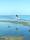 كشف «الجزر» على شاطئ أنجفة عن بضعة صخور شكلت مساحة طبيعية أمام طفلة تلهو في انتظار عودة الملاعب الحقيقية المغلقة بسبب «كورونا»