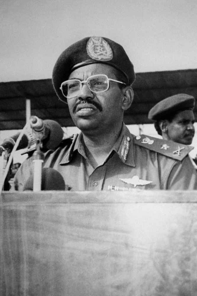 (FILES) In this file photo taken on July 7, 1989, Revolutionary Council ruler and military coup leader General Omar al-Bashir (C) addresses other Revolutionary Council military officers during a graduation ceremony at the Sudanese Military Academy. - Sudanese leader Omar al-Bashir, long wanted on genocide and war crimes charges, was finally brought down in a popular uprising by the very people he ruled with an iron fist for 30 years. One of Africa's longest-serving presidents, the 75-year-old had remained defiant in the face of months-long protests that left dozens of demonstrators dead in clashes with security forces. (Photo by - / AFP)