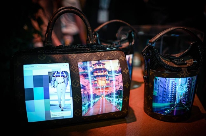 A Louis Vuitton bag with a flexible lcd screen is displayed during the Vivatech startups and innovation fair, in Paris on May 17, 2019. (Photo by Philippe LOPEZ / AFP)