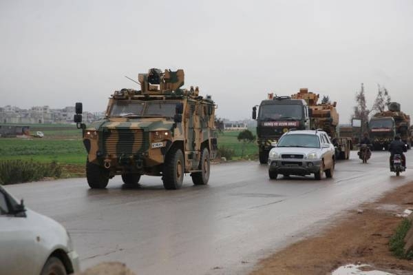 A Turkish military convoy drives on a highway linking Idlib to the Syrian Bab al-Hawa border crossing with Turkey on March 31, 2020. (Photo by Mohammed AL-RIFAI / AFP)