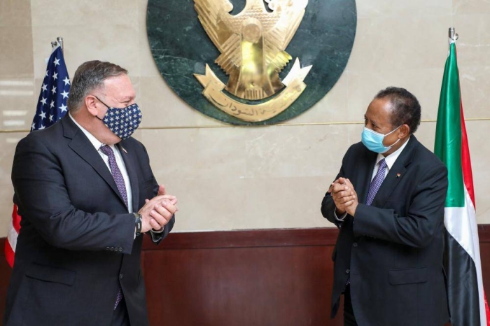 A handout picture provided by Sudan's Prime Ministers office on August 25, 2020, shows US Secretary of State Mike Pompeo (L) greeting Sudanese Prime Minister Abdalla Hamdok (R) in Khartoum. - Pompeo is on an official visit to Sudan to urge more Arab countries to normalise ties with Israel, following the US-brokered Israel-UAE agreement. He is the first American top diplomat to visit Sudan since Condoleezza Rice went in 2005. (Photo by Handout / Office of Sudan's Prime Minister / AFP) / === RESTRICTED TO EDITORIAL USE - MANDATORY CREDIT 