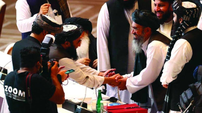 Taliban delegates shake hands during talks between the Afghan government and Taliban insurgents in Doha, Qatar September 12, 2020. REUTERS/Ibraheem al Omari