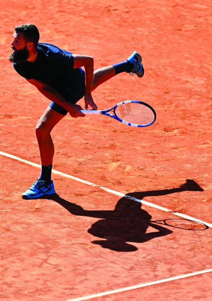 France's Benoit Paire serves to Georgia's Nikoloz Basilashvili during their 2021 ATP Tour Madrid Open tennis tournament singles match at the Caja Magica in Madrid on May 4, 2021. (Photo by GABRIEL BOUYS / AFP)
