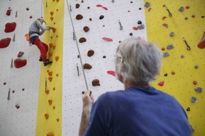 Swiss 98-years-old veteran Alpinists Marcel Remy progresses on a wall as his son Claude holds the rope at the indoor climbing centre in Villeneuve on the eastern shores of Lake Geneva, on May 31, 2021. - Climbing has always been major part of Remy's life. Brought up on tales of the mountains, he never stopped going off to discover the great outdoors and the Alps became his playground. Though he mostly climbs indoors these days, Remy still does sorties into the mountains. In 2017, at the age of 94, he conquered the Miroir de l'Argentine, a Swiss climbing classic with its 500 metres of limestone wall. And he shows no sign of stopping. (Photo by STEFAN WERMUTH / AFP)