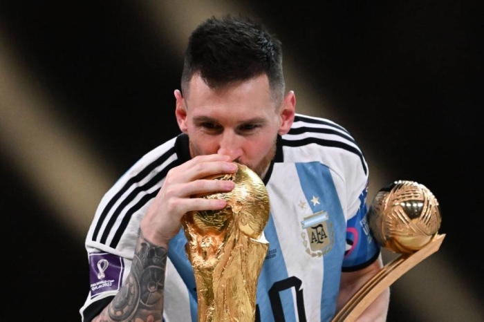 Argentina's captain and forward #10 Lionel Messi kisses the FIFA World Cup Trophy during the trophy ceremony after Argentina won the Qatar 2022 World Cup final football match between Argentina and France at Lusail Stadium in Lusail, north of Doha on December 18, 2022. (Photo by Kirill KUDRYAVTSEV / AFP)