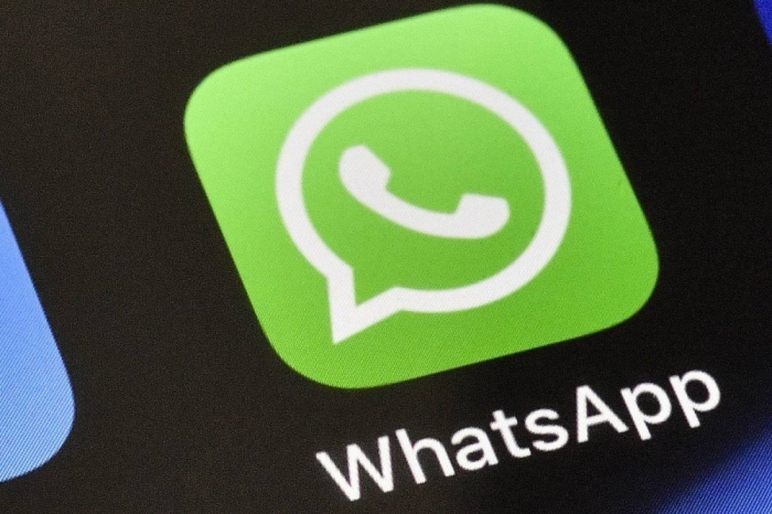 FILE - A WhatsApp icon is displayed on an iPhone, Thursday, Nov. 15, 2018 in Gelsenkirchen, Germany. WhatsApp has chosen the Mercedes Formula One team for its first sports sponsorship, a multi-year agreement that will give followers of the eight-time world champion exclusive team content and in-race updates through the Meta-owned private messaging service.  (AP Photo/Martin Meissner, File)