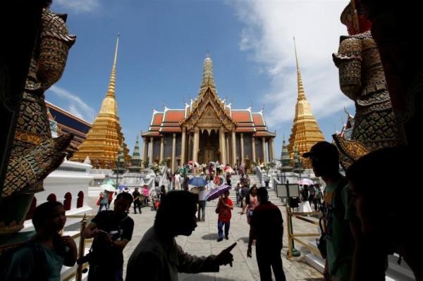 السياحة في تايلاند أمام أحد معالم العاصمة - رويترز