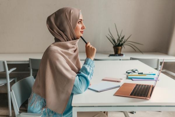 young-pretty-modern-muslim-woman-hijab-working-laptop-office-room-education-online(1)