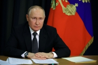 بوتين خلال حضوره جلسة عامة لمجلس الشعب الروسي العالمي- رويترز 