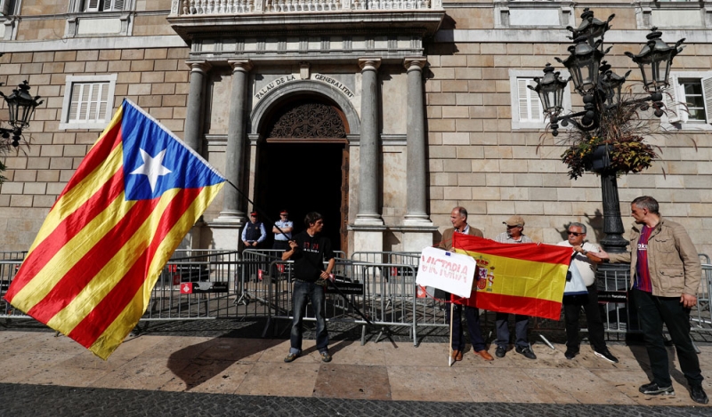 علما كاتالونيا وإسبانيا أمام مقر الحكومة الكاتالونية (رويترز)