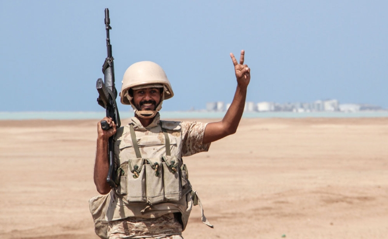 جندي يمني ويظهر خلفه ميناء مخا على الساحل الغربي لتعز (أ ف ب)