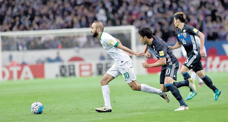 صراع سعودي ياباني على الكرة خلال قمة المنتخبين التي جمعتهما في الدور الأول من التصفيات النهائية (اليوم)