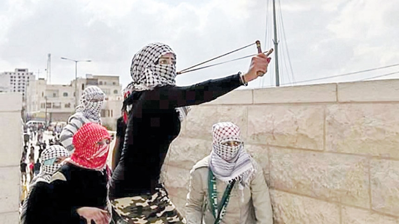 فلسطينية تستخدم المقلاع في مواجهة جنود الاحتلال الإسرائيلي