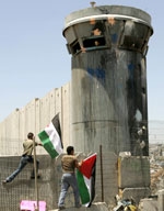 اطفال فلسطينيون يتحدون الاحتلال ويتسلقون الجدار العنصري امام برج مراقبة اسرائيلي	