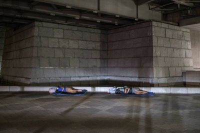 Homeless people sleep on the street in Tokyo's Shinjuku Ward in August 2021.