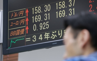 A monitor shows the yen's sharp decline to  ¥158 to the dollar on Saturday morning in Tokyo.
