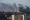 基辅西部有公寓大楼遭导弹或火箭炮击中，然后发生火灾。图示市内上空周六出现浓烟。-路透社-