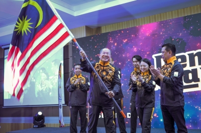 柬埔寨金边东运会大马代表团团长拿督莫哈末纳西尔,在授旗礼上从青体部长杨巧双手中接过“辉煌条纹”后就挥舞起来。-马新社- 柬埔寨金边东运会大马代表团团长拿督莫哈末纳西尔,在授旗礼上从青体部长杨巧双手中接过“辉煌条纹”后就挥舞起来。-马新社-