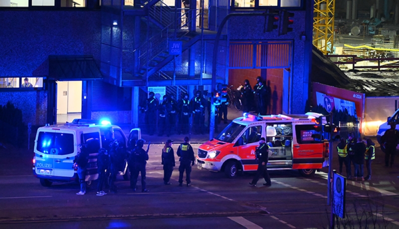 Police and an ambulance are seen near the site of a shooting at a church in Hamburg, northern Germany, where several people were killed on March 9, 2023 / AFP.