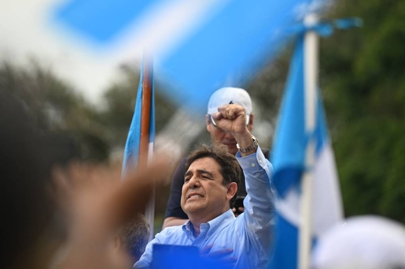 Guatemalan presidential candidate Carlos Pineda (center) of the Prosperida Ciudadana Party speaks with supporters outside the Constitutional Court of Guatemala City on May 20, 2023.