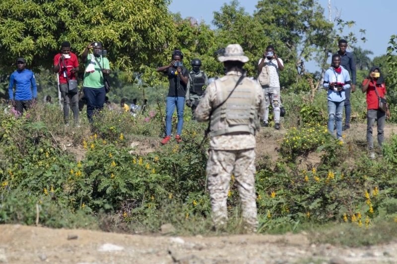 Dominican soldiers from the Haitian Border Guard (CESFRONT) observe Haitian nationals during a militarized operation on the Haitian border.