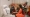 Sylvie Tagro épouse Soro (en orange) au chevet de Henriette Konan Bédié. (Dr)