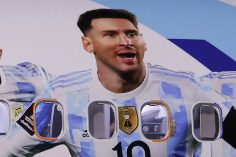 A picture of Argentina&#039;s forward Lionel Messi is displayed on the plane as the team arrive at the Hamad International Airport. (Photo by Odd ANDERSEN / AFP)