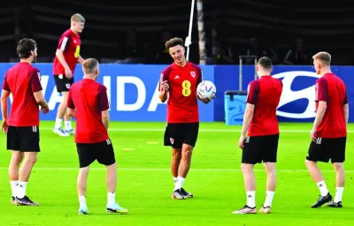 Wales’ defender Ethan Ampadu (centre) chats with teammates during a training session at the Al Sadd Stadium in Doha yesterday. (AFP)
