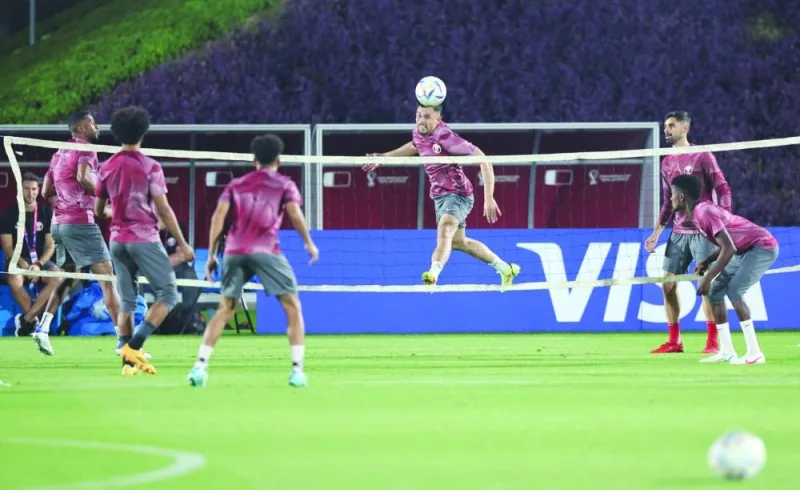 Qatar's defender Bassam Al Rawi (back center)heads the ball during a training session in Doha on November 17, 2022, ahead of the Qatar 2022 World Cup football tournament. (Photo by KARIM JAAFAR / AFP)